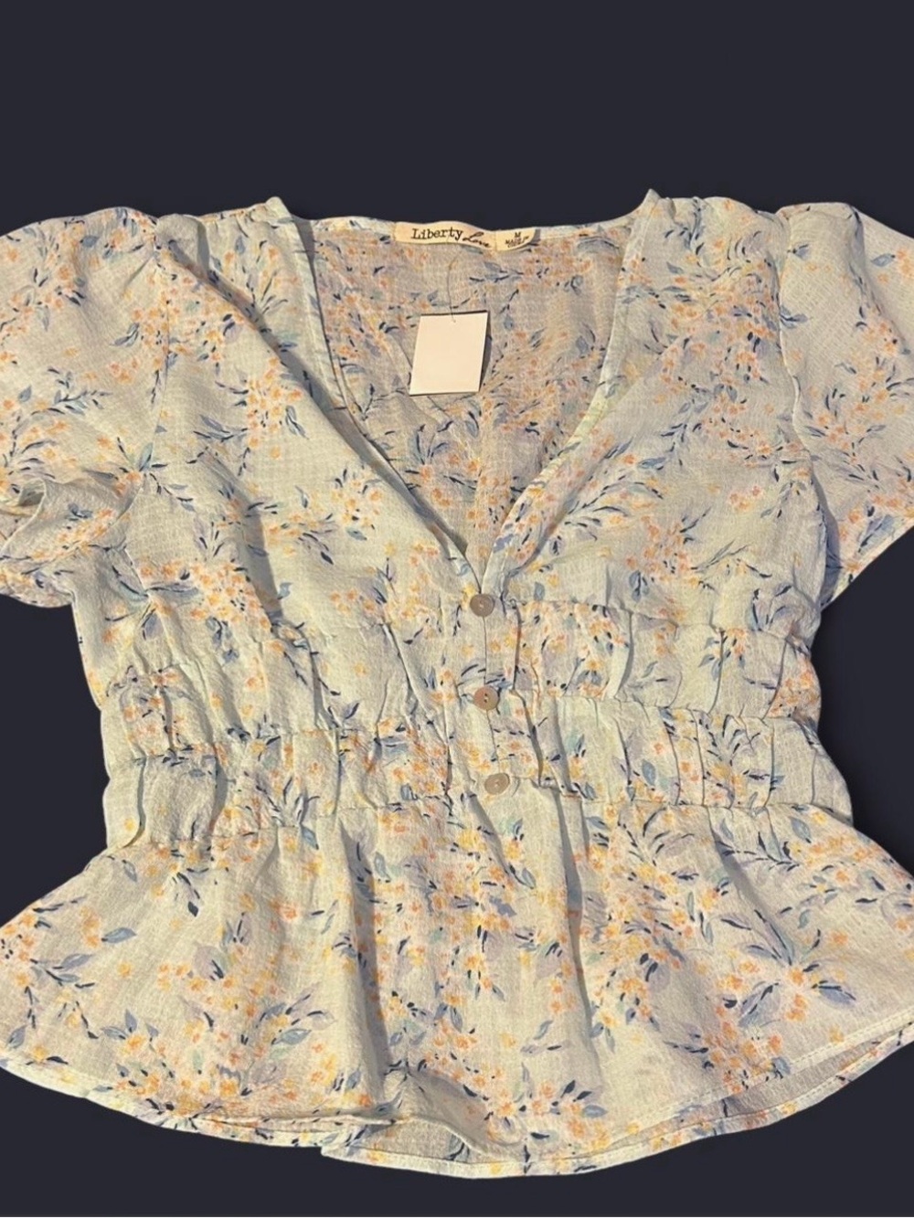 Liberty Love baby blue floral blouse with button up front and ruffle hem